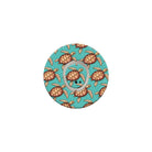 Circular product with turtle pattern on a turquoise background