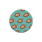 Round coaster with turtle pattern on a turquoise background