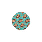 Round turquoise coaster with turtle pattern on a white background