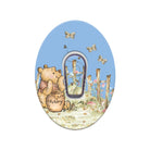 Oval-shaped decorative item with a bear holding a honey pot and flowers on a blue background