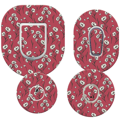 Four circular coasters with floral pattern on a red background